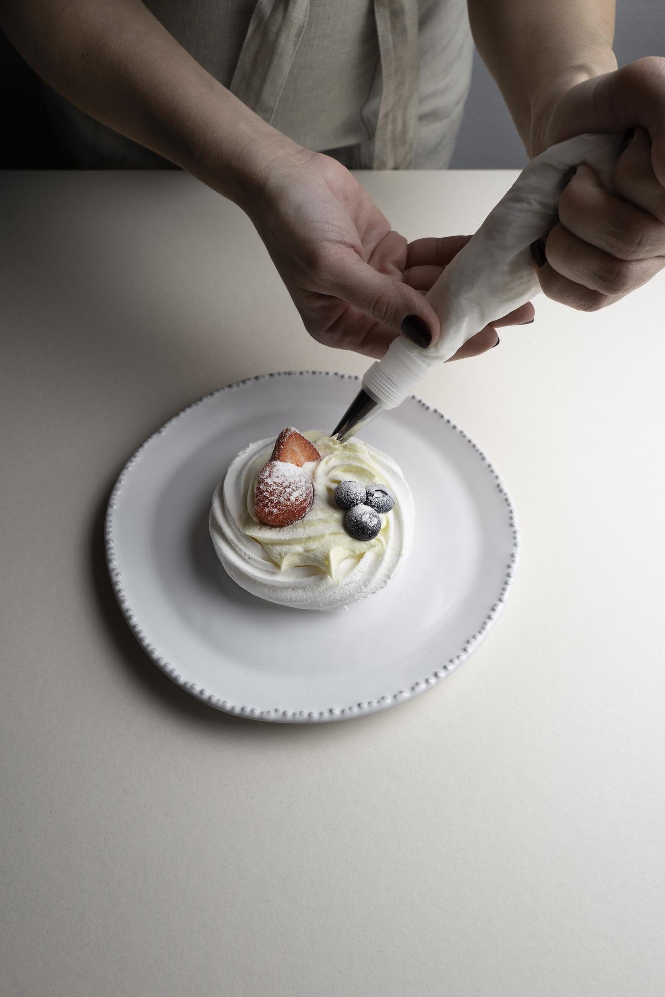 Large editorial shot of chef plating a dessert
