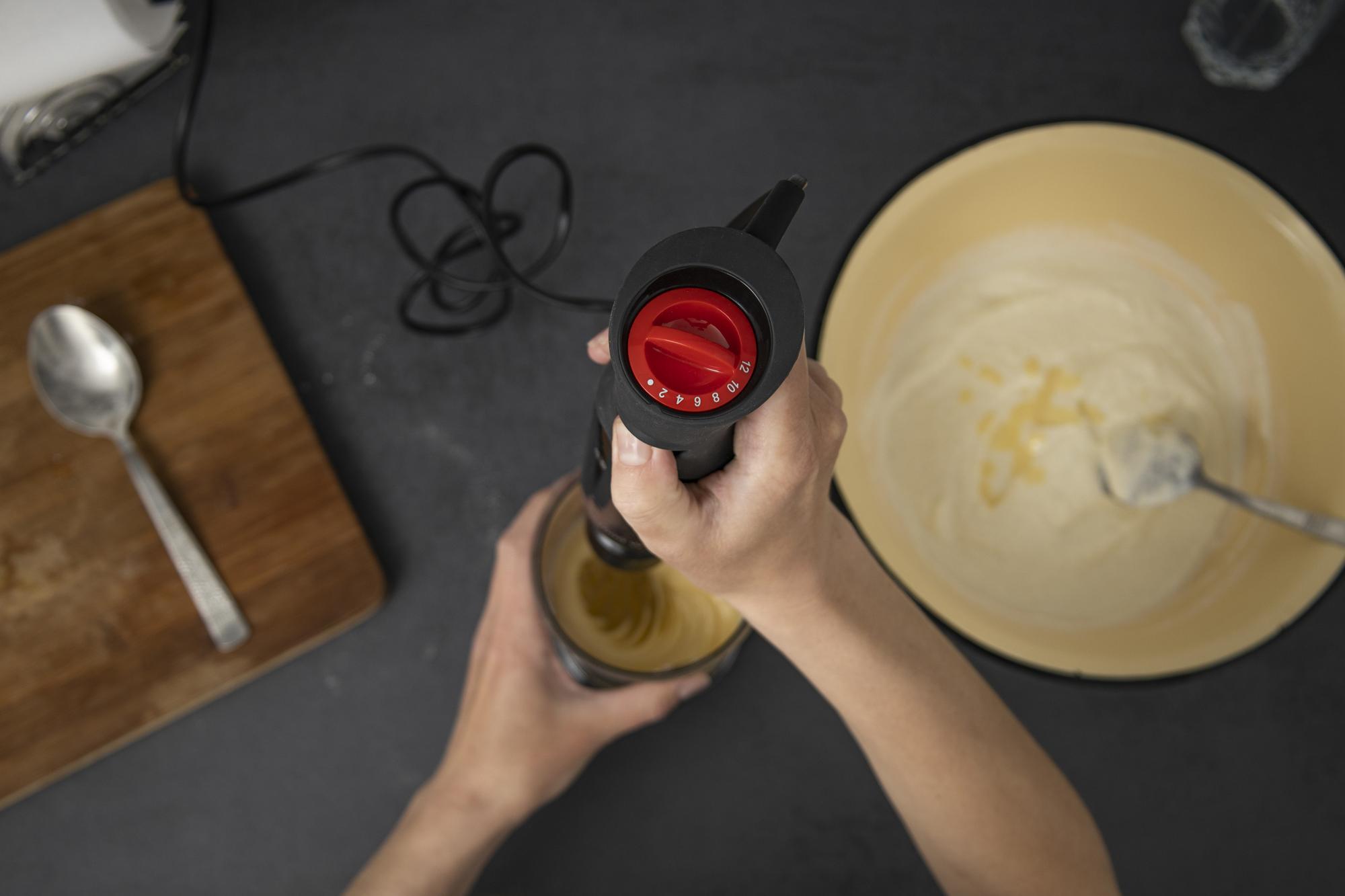Close-up of hands whisking sauce